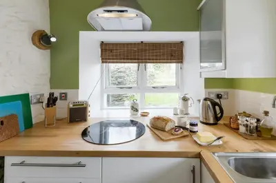a kitchen counter with a sink and a window at Hen Ffermdy Aberaeron in Cross Inn