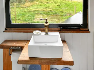 a bathroom with a sink and a window at Myfanwy in Ciliau-Aeron