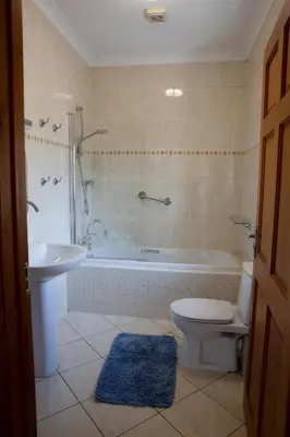 a bathroom with a tub and a toilet and a sink at Aberystwyth Dinas Cottage in Llanilar