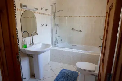 a bathroom with a sink and a tub and a toilet at Aberystwyth Dinas Cottage in Llanilar