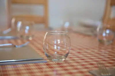 a row of empty glasses sitting on a table at Aberystwyth Enlli Cottage in Llanilar