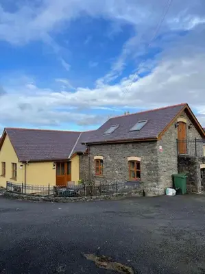 a brick building with windows and a roof at Aberystwyth Cottage Ilar in Llanilar