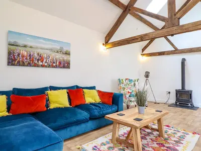 a living room with a blue couch and a table at The Granary in Montgomery