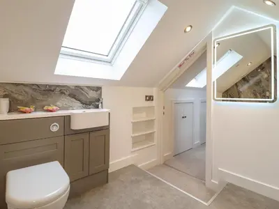a bathroom with a toilet and a skylight at The Granary in Montgomery