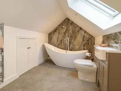 a bathroom with a tub and a toilet and a sink at The Granary in Montgomery