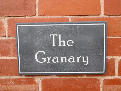 a sign on a brick wall that reads the granny at The Granary in Montgomery