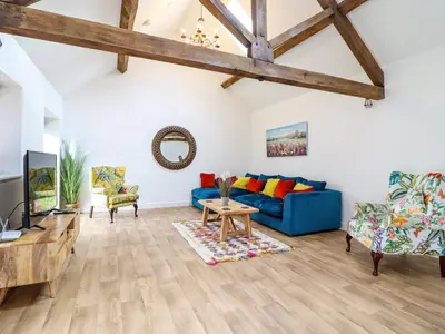 a living room with a blue couch and a table at The Granary in Montgomery