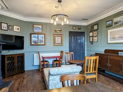 a living room with a table and a couch at Cartref Guesthouse - Room 1 Ensuite in Aberdyfi