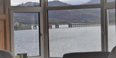 a view of a bridge from a window at Wynnstay Apartment, Harbour and Mountain Views in Barmouth