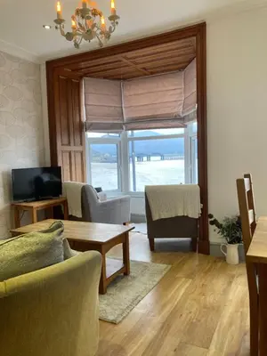 a living room with a couch and a table at Wynnstay Apartment, Harbour and Mountain Views in Barmouth