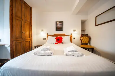a bedroom with a bed with a red stuffed animal on it at Without A Paddle Hotel in Llangollen