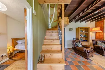 a stairway leading to a living room with a couch at 3 Bed in Llanrhystud oc-m28913 in Llanrhystyd