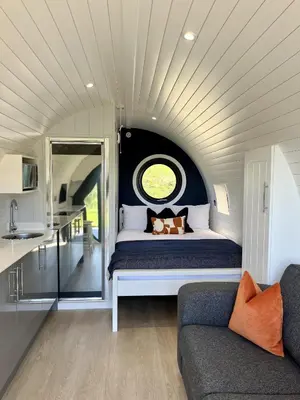 a room with a bed with a window and a couch at Y Fedwen in Llanwddyn