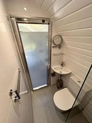 a small bathroom with a toilet and a sink at Y Fedwen in Llanwddyn