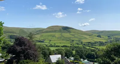 a view of a valley with green hills at Chalet 8 The Woodlands in Tywyn
