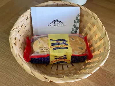 a basket of cheese and crackers in a box at Chalet 8 The Woodlands in Tywyn