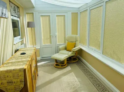 a room with a chair and a desk and windows at Snowdonia coastal getaway ideal for groups up to 6 in Llwyngwril
