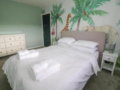 a bedroom with a white bed with towels on it at Timberdyne in Ludlow