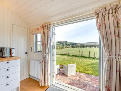 a kitchen with a large window with a view of a field at Sunflower - Uk42360 in Saint Harmon