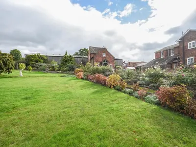 a garden in front of a house at The Old Coach House -Uk41272 in Great Hanwood