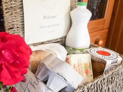 a basket filled with food and a bottle of milk at The Old Coach House -Uk41272 in Great Hanwood