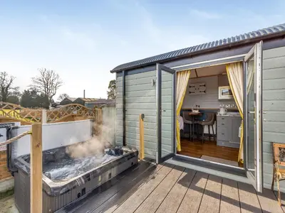 a tiny house with a grill on a deck at Tulip - Uk42363 in Saint Harmon