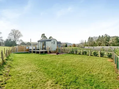 a caravan in a field with a fence at Tulip - Uk42363 in Saint Harmon