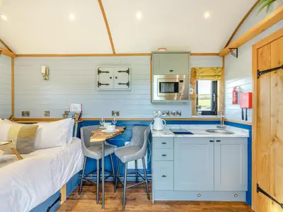 a kitchen with a couch and a table in a room at Tulip - Uk42363 in Saint Harmon