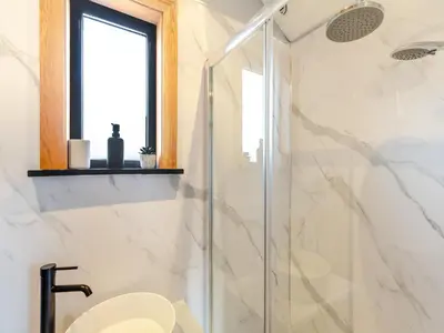 a bathroom with a shower with a toilet and a window at Tulip - Uk42363 in Saint Harmon