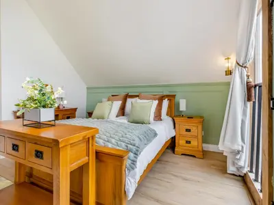 a bedroom with a bed and a wooden table at The Lodge Spa - Uk47837 in Church Pulverbatch