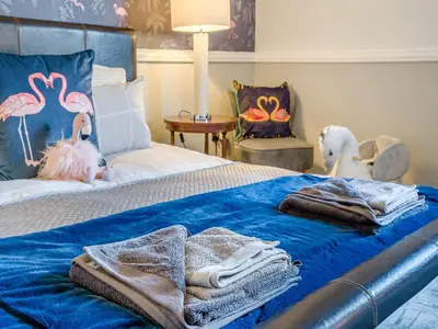 a bedroom with a bed with towels and a chair at Cromwell House - Uk42450 in Winforton