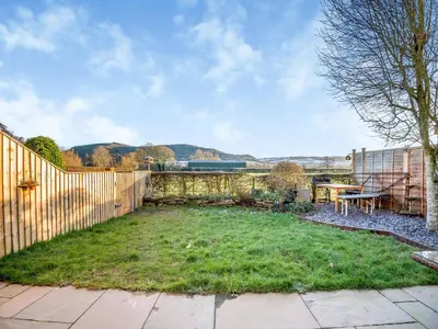 a backyard with a fence and a grass yard at Cromwell House - Uk42450 in Winforton