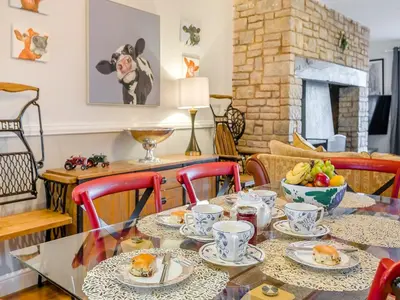 a dining room with a table with plates of food at Cromwell House - Uk42450 in Winforton