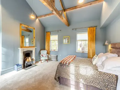 a bedroom with a bed and a fireplace at Apartment At Llanerchydol Hall in Welshpool