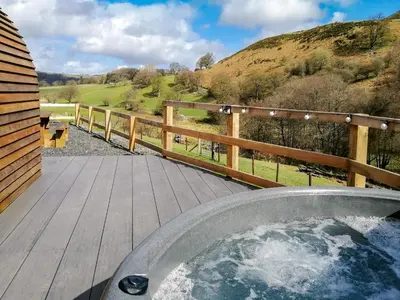 a jacuzzi tub on a deck with a view at Glampio Trysor Merddwr-Ukc5826 in Llangwm