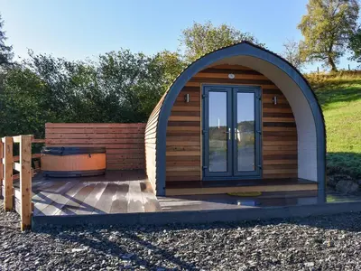 a small wooden cabin with a hot tub in it at Glampio Trysor Merddwr-Ukc5826 in Llangwm