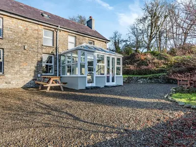 a greenhouse sits outside of a house at East Llwyn - Uk41756 in Rhyd Owen