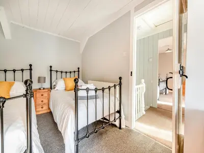 a bedroom with a bed and a mirror at East Llwyn - Uk41756 in Rhyd Owen
