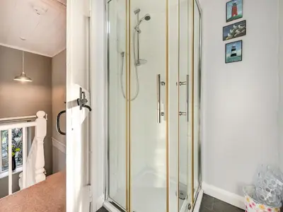 a shower with a glass door in a bathroom at East Llwyn - Uk41756 in Rhyd Owen
