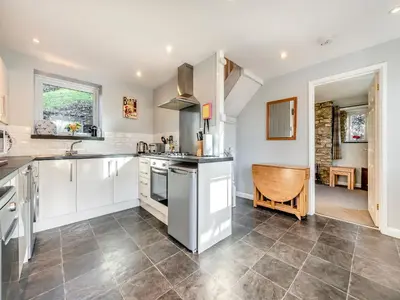 a kitchen with white cabinets and a counter top at East Llwyn - Uk41756 in Rhyd Owen