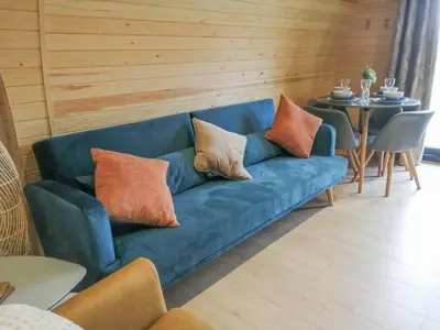 a blue couch with pillows on it in a room at Glampio Tryso Garth-Ukc5827 in Llangwm