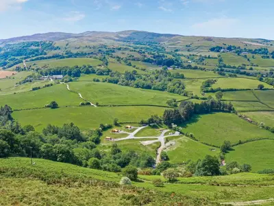 a view of green hills with a road in the middle at Glampio Tryso Garth-Ukc5827 in Llangwm