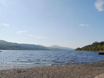 a lake with a bunch of birds in the water at Glampio Tryso Garth-Ukc5827 in Llangwm