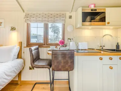 a kitchen with a table and a chair in a room at Mayflower - Uk42359 in Saint Harmon