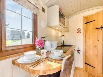 a tiny kitchen with a table and a sink at Mayflower - Uk42359 in Saint Harmon