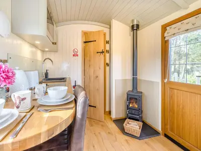 a kitchen and dining room with a wood stove at Mayflower - Uk42359 in Saint Harmon