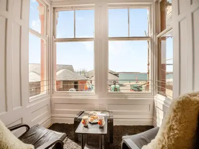 a room with a large window with a view of the ocean at Apartment 2 in Aberdyfi