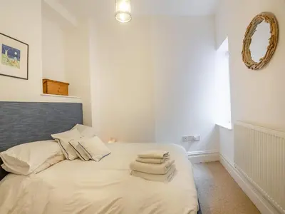 a bedroom with a bed with towels on it at Apartment 2 in Aberdyfi