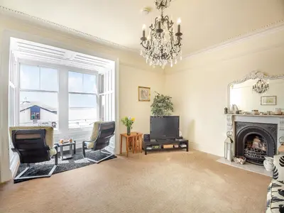 a living room with a fireplace and a television at Apartment 2 in Aberdyfi