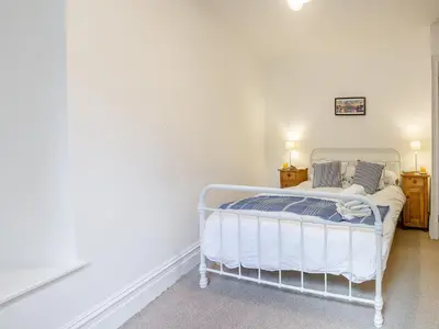 a bedroom with a white bed in a room at Apartment 2 in Aberdyfi